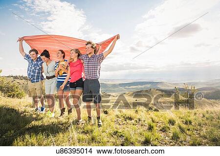 Picture - Teenage girl and adult friends holding up blanket, Bridger, Montana, USA. Fotosearch