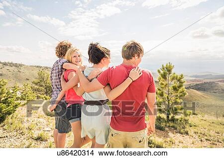 Teenage girl and adult friends looking out over landscape, Bridger, Montana, USA View Large Photo Image Picture - Teenage girl and adult friends looking out over landscape, Bridger, Montana, USA. Fotosearch