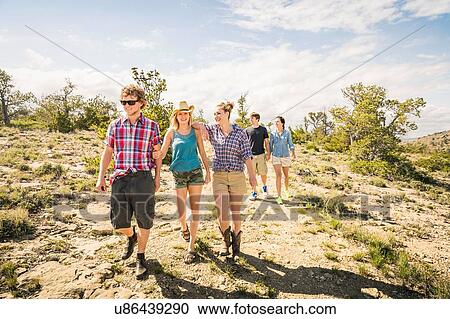Teenage girl and adult friends walking on dirt track, Bridger, Montana, USA View Large Photo Image Stock Image - Teenage girl and adult friends walking on dirt track, Bridger, Montana, USA. Fotosearch