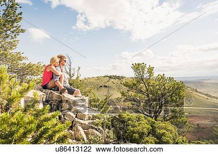 Teenage girl and boyfriend sitting on rocks looking out over landscape, Bridger, Montana, USA View Large Photo Image Stock Image - Teenage girl and boyfriend sitting on rocks looking out over landscape, Bridger, Montana, USA. Fotosearch