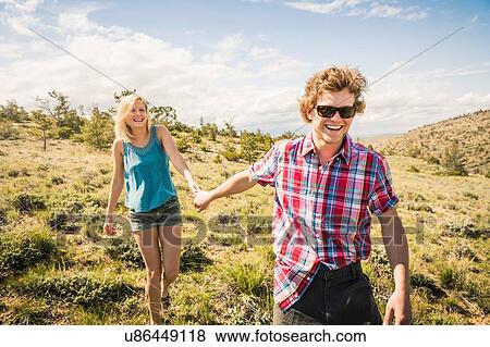 Teenage girl and boyfriend walking in hills, Bridger, Montana, USA View Large Photo Image Stock Photo - Teenage girl and boyfriend walking in hills, Bridger, Montana, USA. Fotosearch