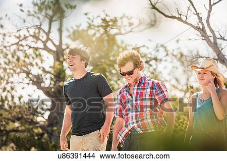 Teenage girl and male adult friends walking, Bridger, Montana, USA View Large Photo Image Picture - Teenage girl and male adult friends walking, Bridger, Montana, USA. Fotosearch
