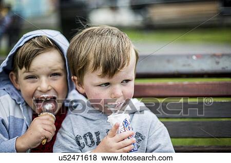 Two boys eating ice creams View Large Photo Image Stock Photo - Two boys eating ice creams. Fotosearch