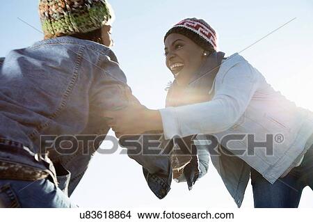 "Two friends fooling around at beach, laughing" View Large Photo Image Picture - "Two friends fooling around at beach, laughing". Fotosearch
