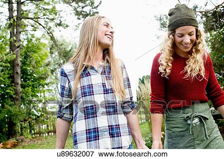 Two women in garden, smiling View Large Photo Image Stock Photo - Two women in garden, smiling. Fotosearch