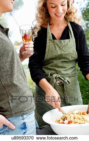 Two women preparing food View Large Photo Image Stock Image - Two women preparing food. Fotosearch