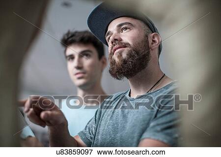 Stock Photo - Two young men at office reception. Fotosearch