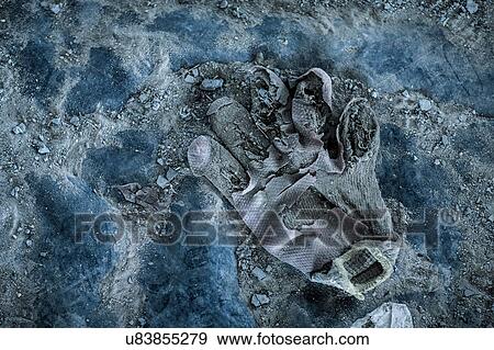Stock Photo - Used protective glove on floor of construction site. Fotosearch