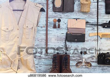 Variety of objects on blue wooden wall including camera, dress and purse View Large Photo Image Stock Photograph - Variety of objects on blue wooden wall including camera, dress and purse. Fotosearch