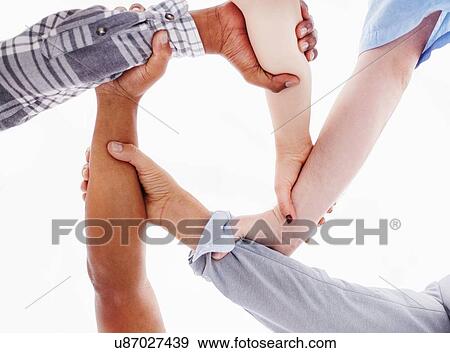 Stock Photo - View from below of people holding wrists. Fotosearch