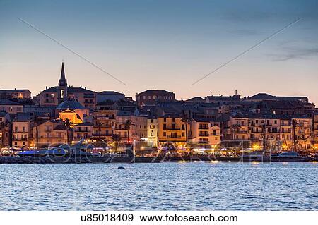 View of sea and Calvi city lights at dusk, Corsica, France View Large Photo Image Stock Photo - View of sea and Calvi city lights at dusk, Corsica, France. Fotosearch