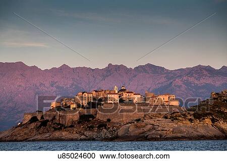 View of sea and Calvi on headland at dusk, Corsica, France View Large Photo Image Stock Image - View of sea and Calvi on headland at dusk, Corsica, France. Fotosearch