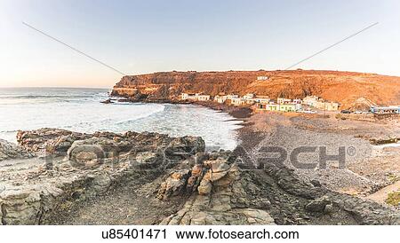 Stock Image -  Village on rugged coastline, Puertito Los Molinos, Fuerteventura, Spain. Fotosearch
