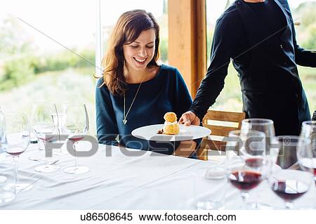 Waiter serving profiterole with whipped cream to woman in restaurant, Italy View Large Photo Image Stock Photography - Waiter serving profiterole with whipped cream to woman in restaurant, Italy. Fotosearch