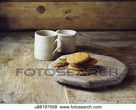 Stock Photo - Wheat digestive biscuits on vintage wooden cutting board. Fotosearch