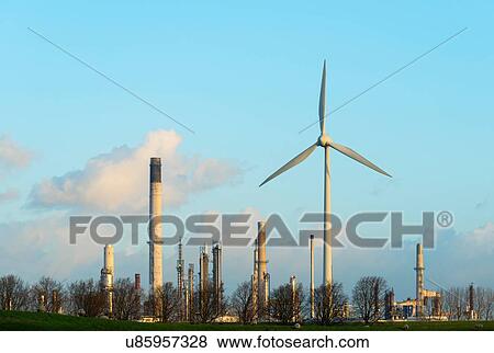 Stock Photo - Wind turbine in front of oil refinery, Rotterdam, Zuid-Holland, The Netherlands. Fotosearch