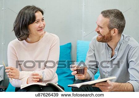 Stock Photo - Woman and man chatting at coffee break. Fotosearch