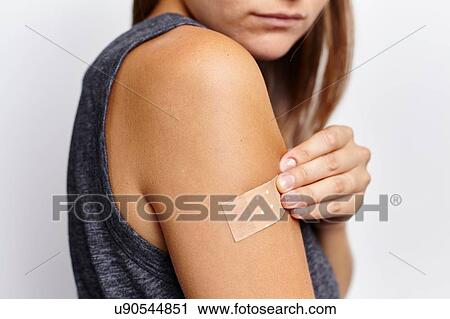 Woman applying plaster on right arm View Large Photo Image Stock Image - Woman applying plaster on right arm. Fotosearch