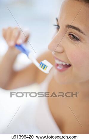 Woman brushing teeth View Large Photo Image Stock Image - Woman brushing teeth. Fotosearch