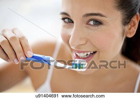Woman brushing teeth View Large Photo Image Stock Image - Woman brushing teeth. Fotosearch