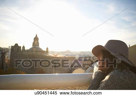 Stock Photography - Woman enjoying view from terrace, Seville, Spain. Fotosearch