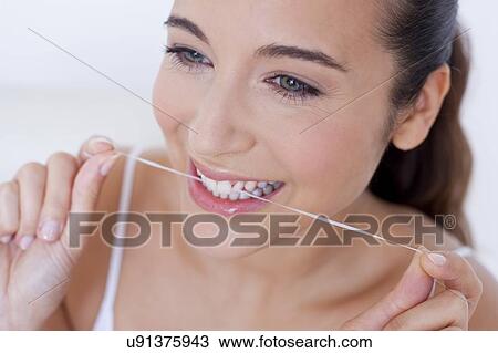 Woman flossing teeth View Large Photo Image Stock Image - Woman flossing teeth. Fotosearch