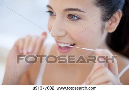 Woman flossing teeth View Large Photo Image Stock Image - Woman flossing teeth. Fotosearch