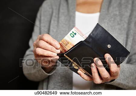 Woman getting money out of her wallet View Large Photo Image Stock Photo - Woman getting money out of her wallet. Fotosearch