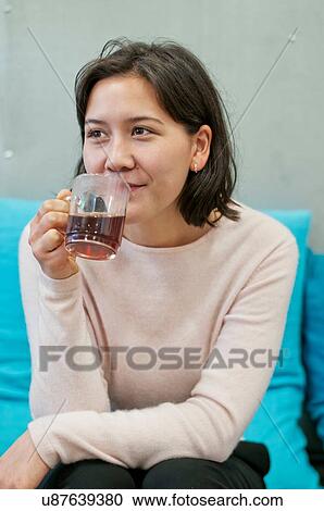 Stock Image - Woman having coffee. Fotosearch