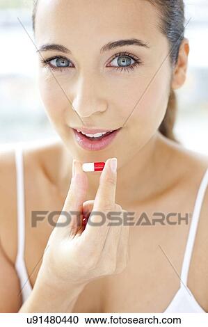 Woman holding a capsule View Large Photo Image Stock Image - Woman holding a capsule. Fotosearch