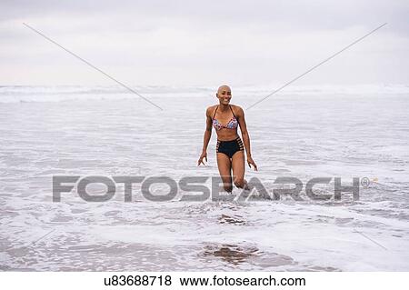 Woman in bikini standing in ocean View Large Photo Image Stock Photo - Woman in bikini standing in ocean. Fotosearch