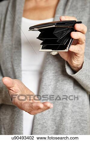 Woman looking for loose change in coin purse View Large Photo Image Stock Image - Woman looking for loose change in coin purse. Fotosearch