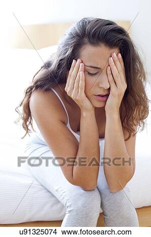 Woman on bed in pain View Large Photo Image Picture - Woman on bed in pain. Fotosearch