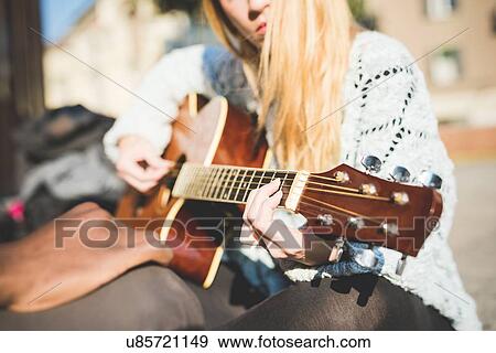 Stock Photo - Woman playing guitar. Fotosearch
