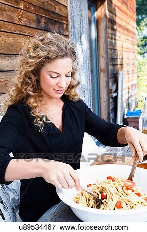 Stock Photo - Woman preparing lunch al fresco. Fotosearch