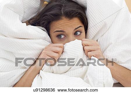 Woman pulling bedclothes over her face View Large Photo Image Stock Photograph - Woman pulling bedclothes over her face. Fotosearch