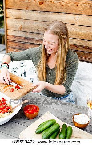 Woman scarping tomatoes into bowl from chopping board View Large Photo Image Stock Image - Woman scarping tomatoes into bowl from chopping board. Fotosearch