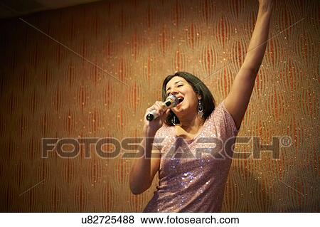 Woman singing karaoke View Large Photo Image Stock Photo - Woman singing karaoke. Fotosearch