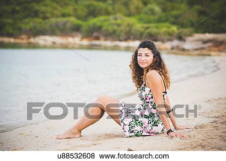 Woman sitting on beach View Large Photo Image Stock Photo - Woman sitting on beach. Fotosearch