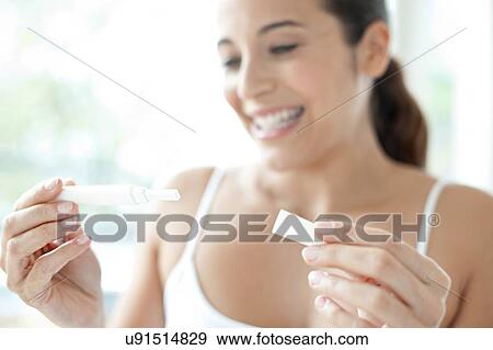 Stock Photo - Woman taking pregnancy test. Fotosearch