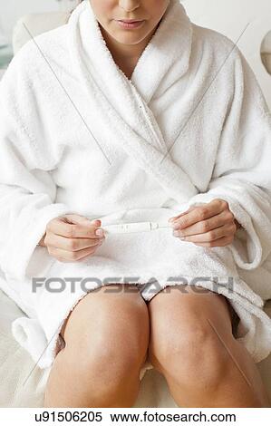 Stock Photography - Woman taking pregnancy test. Fotosearch