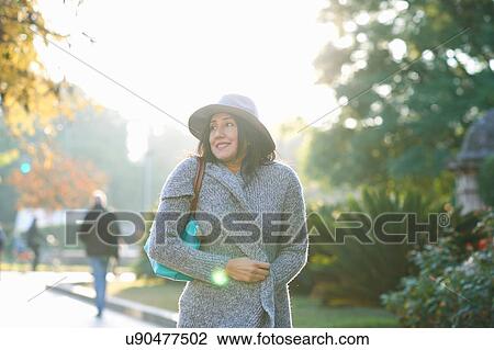 Stock Image - Woman walking in park, Seville, Spain. Fotosearch