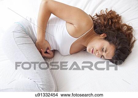 Woman with cramps View Large Photo Image Picture - Woman with cramps. Fotosearch