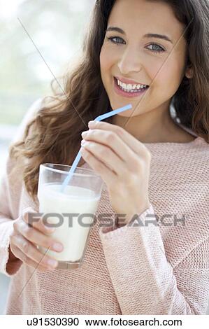 Woman with glass of milk View Large Photo Image Stock Image - Woman with glass of milk. Fotosearch