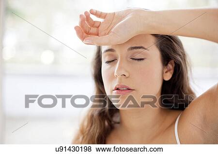 Woman with hand on forehead View Large Photo Image Stock Photo - Woman with hand on forehead. Fotosearch