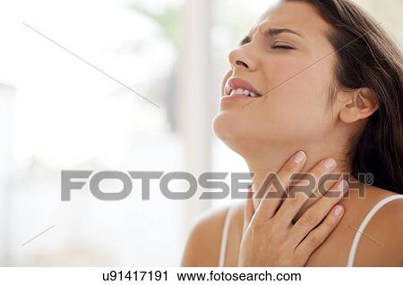 Woman with hand on throat in pain View Large Photo Image Stock Image - Woman with hand on throat in pain. Fotosearch