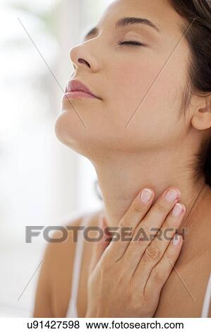 Woman with hand on throat View Large Photo Image Stock Photo - Woman with hand on throat. Fotosearch
