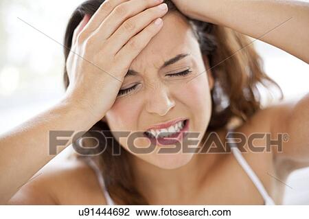 Stock Image - Woman with hands in hair. Fotosearch