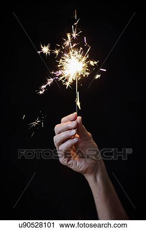 Woman's hand holding sparkler View Large Photo Image Stock Image - Woman's hand holding sparkler. Fotosearch