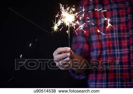 Woman's hand holding sparkler View Large Photo Image Stock Photo - Woman's hand holding sparkler. Fotosearch